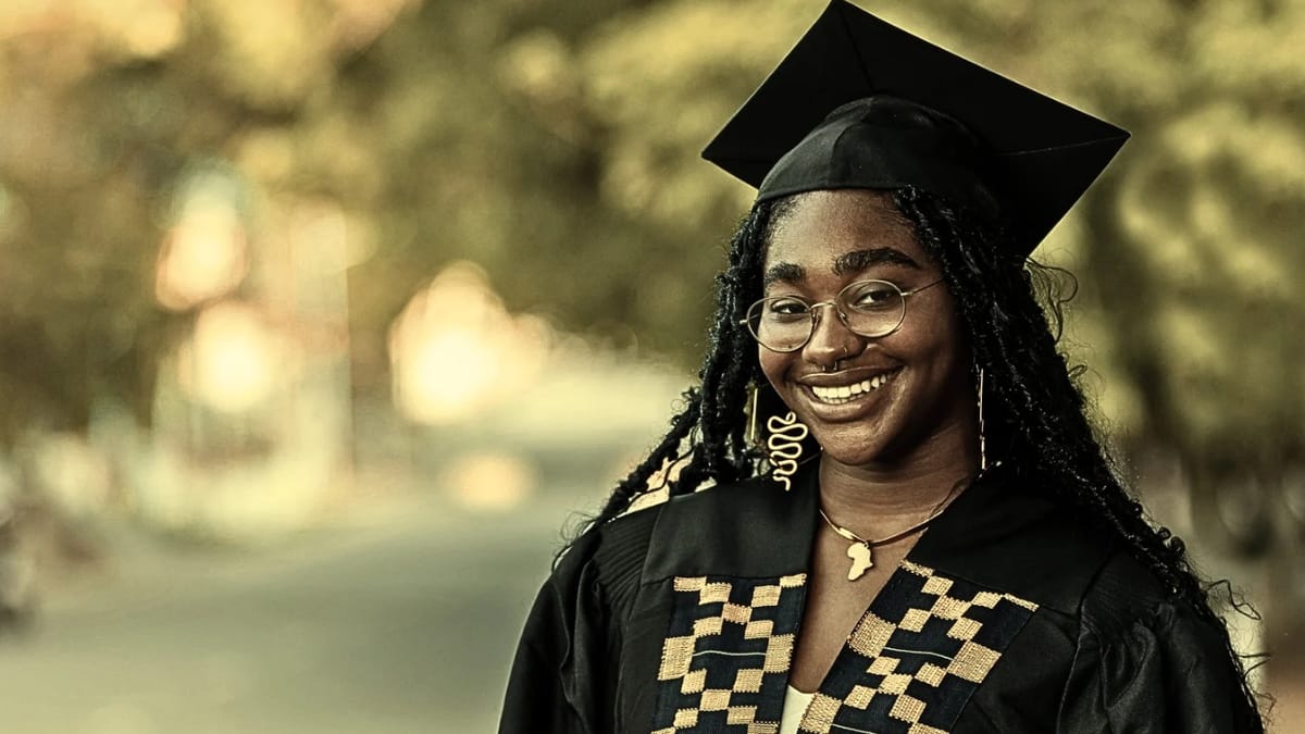 A graduate smiling in cap and gown