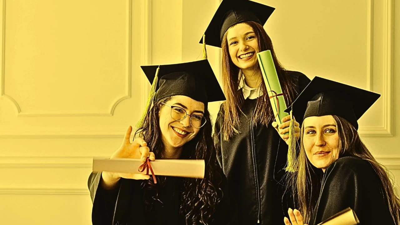 Graduates holding up their certificates